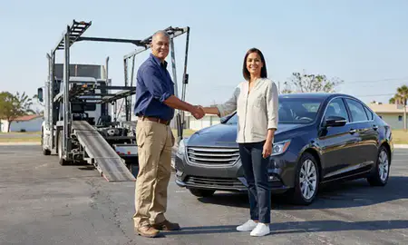 Vehicle owner beside their delivered car in Tallahassee, Florida, United States