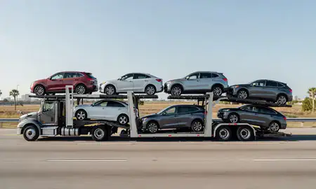 Multi-level car carrier on the highway to Tampa, Florida, United States