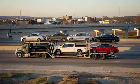 Car transporter with the Gainesville, Georgia, United States skyline behind it