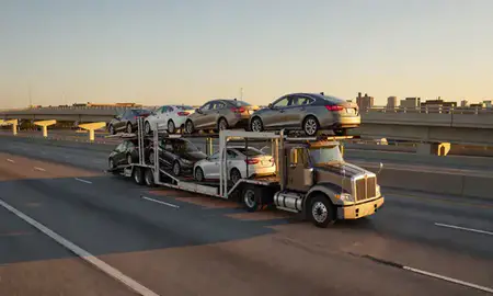 Car transporter with the Macon, Georgia, United States skyline behind it