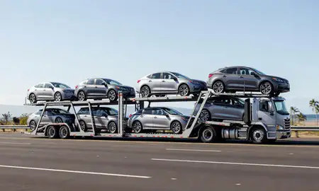 Multi-level car carrier on the highway to Hawaii, United States