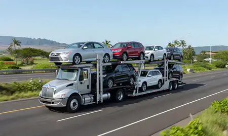 Multi-level car carrier on the highway to East Honolulu, Hawaii, United States