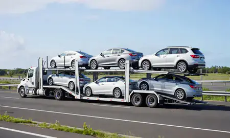 Multi-level car carrier on the highway to Ewa Beach, Hawaii, United States