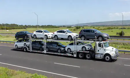Multi-level car carrier on the highway to Halawa, Hawaii, United States