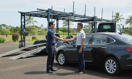 Vehicle owner beside their delivered car in Halawa, Hawaii, United States