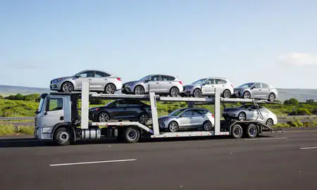 Multi-level car carrier on the highway to Hawaiian Paradise Park, Hawaii, United States