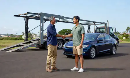Vehicle owner beside their delivered car in Hilo, Hawaii, United States