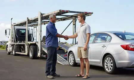 Vehicle owner beside their delivered car in Kahului, Hawaii, United States