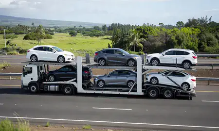 Multi-level car carrier on the highway to Kailua, Hawaii, United States