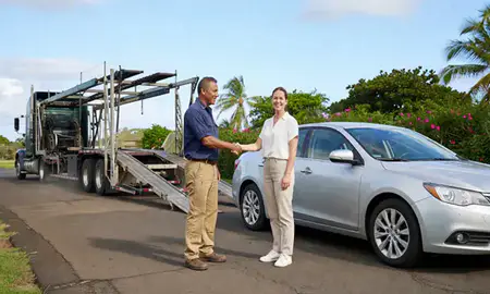 Vehicle owner beside their delivered car in Kaneohe, Hawaii, United States