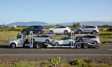 Multi-level car carrier on the highway to Kapaa, Hawaii, United States