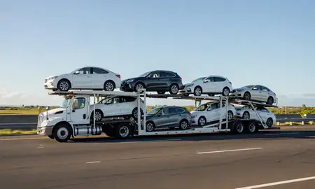 Multi-level car carrier on the highway to Kapolei, Hawaii, United States