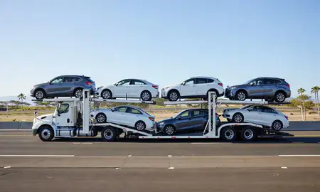 Multi-level car carrier on the highway to Kihei, Hawaii, United States