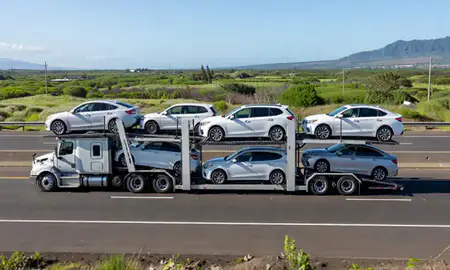 Multi-level car carrier on the highway to Lahaina, Hawaii, United States