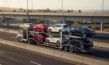 Car transporter with the Lahaina, Hawaii, United States skyline behind it