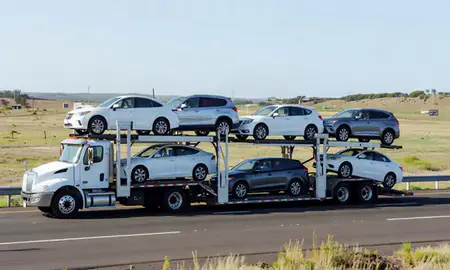 Multi-level car carrier on the highway to Makakilo, Hawaii, United States