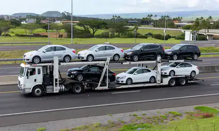 Multi-level car carrier on the highway to Mililani Town, Hawaii, United States