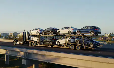 Car transporter with the Nanakuli, Hawaii, United States skyline behind it
