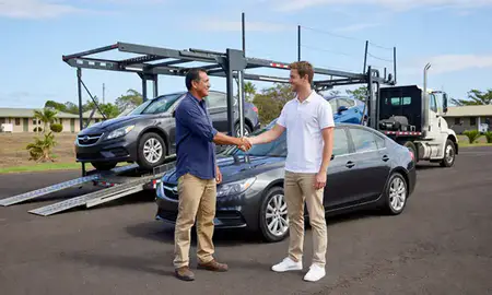 Vehicle owner beside their delivered car in Schofield Barracks, Hawaii, United States