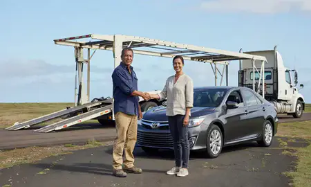 Vehicle owner beside their delivered car in Waianae, Hawaii, United States