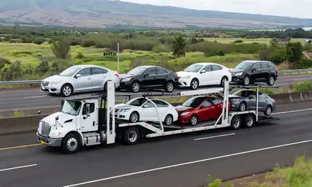 Multi-level car carrier on the highway to Waihee-Waiehu, Hawaii, United States