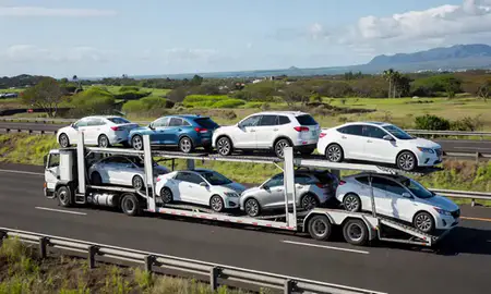 Multi-level car carrier on the highway to Wailuku, Hawaii, United States