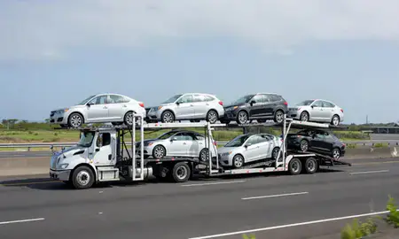 Multi-level car carrier on the highway to Waipahu, Hawaii, United States