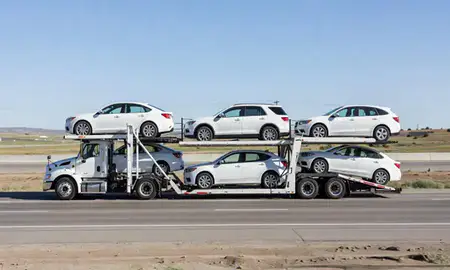 Multi-level car carrier on the highway to Idaho, United States