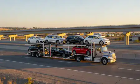 Car transporter with the Star, Idaho, United States skyline behind it