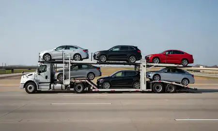 Multi-level car carrier on the highway to Illinois, United States
