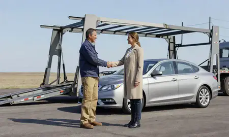 Vehicle owner beside their delivered car in Illinois, United States