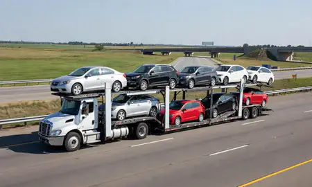Multi-level car carrier on the highway to Peoria, Illinois, United States