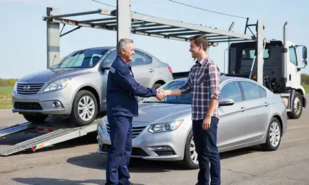 Vehicle owner beside their delivered car in Indiana, United States