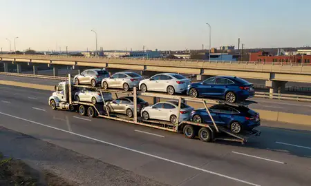 Car transporter with the Hammond, Indiana, United States skyline behind it