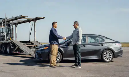 Vehicle owner beside their delivered car in Michigan City, Indiana, United States