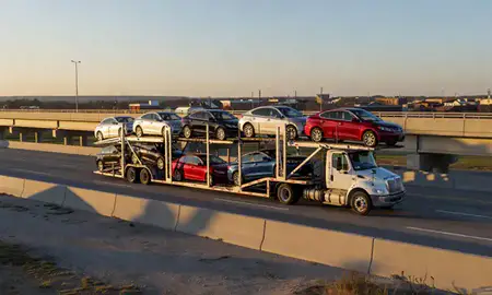 Car transporter with the Mishawaka, Indiana, United States skyline behind it
