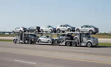 Multi-level car carrier on the highway to Ames, Iowa, United States