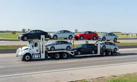 Multi-level car carrier on the highway to Bettendorf, Iowa, United States