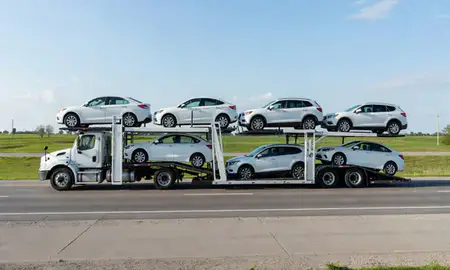 Multi-level car carrier on the highway to Burlington, Iowa, United States