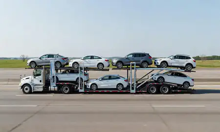 Multi-level car carrier on the highway to Cedar Falls, Iowa, United States