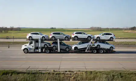 Multi-level car carrier on the highway to Cedar Rapids, Iowa, United States