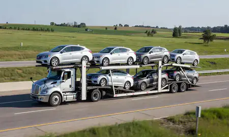 Multi-level car carrier on the highway to Dubuque, Iowa, United States
