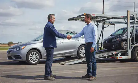 Vehicle owner beside their delivered car in Indianola, Iowa, United States