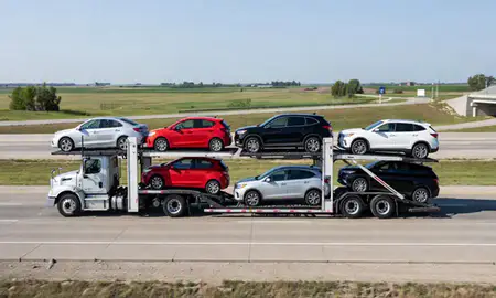 Multi-level car carrier on the highway to Mason City, Iowa, United States