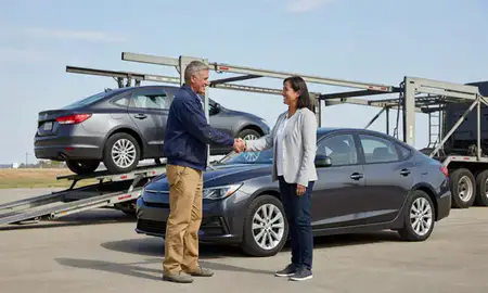 Vehicle owner beside their delivered car in Muscatine, Iowa, United States
