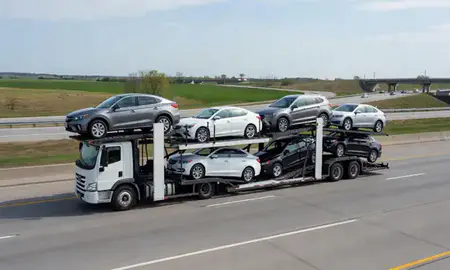 Multi-level car carrier on the highway to Ottumwa, Iowa, United States