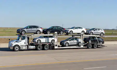 Multi-level car carrier on the highway to Arkansas City, Kansas, United States