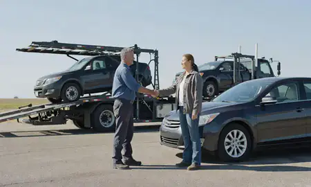 Vehicle owner beside their delivered car in El Dorado, Kansas, United States