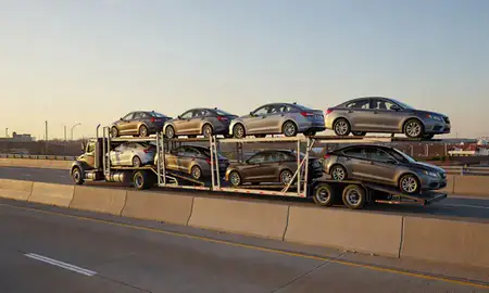 Car transporter with the Leavenworth, Kansas, United States skyline behind it