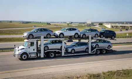 Multi-level car carrier on the highway to Manhattan, Kansas, United States